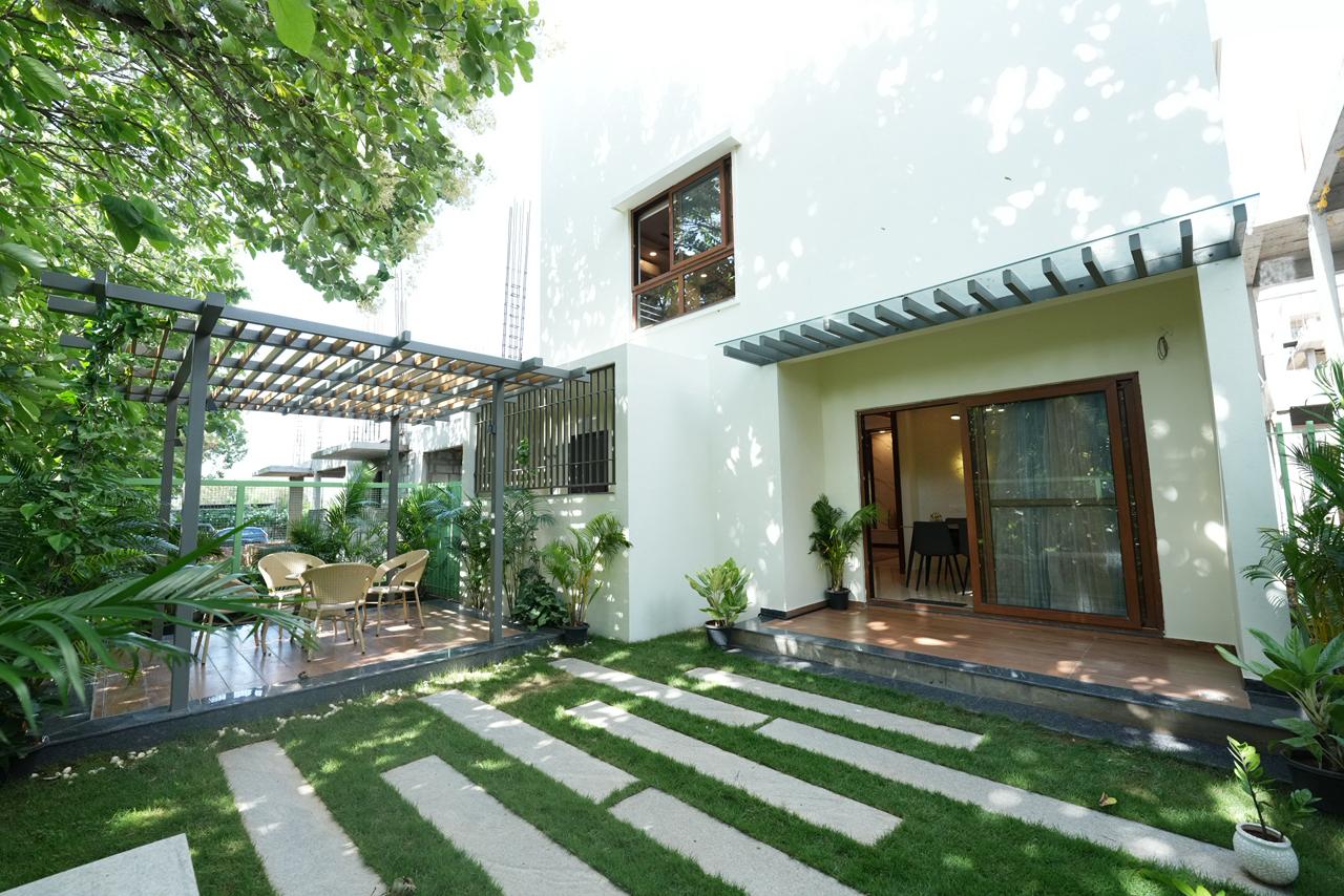 Shaded pergola sit-out and sliding door entrance opening onto the garden