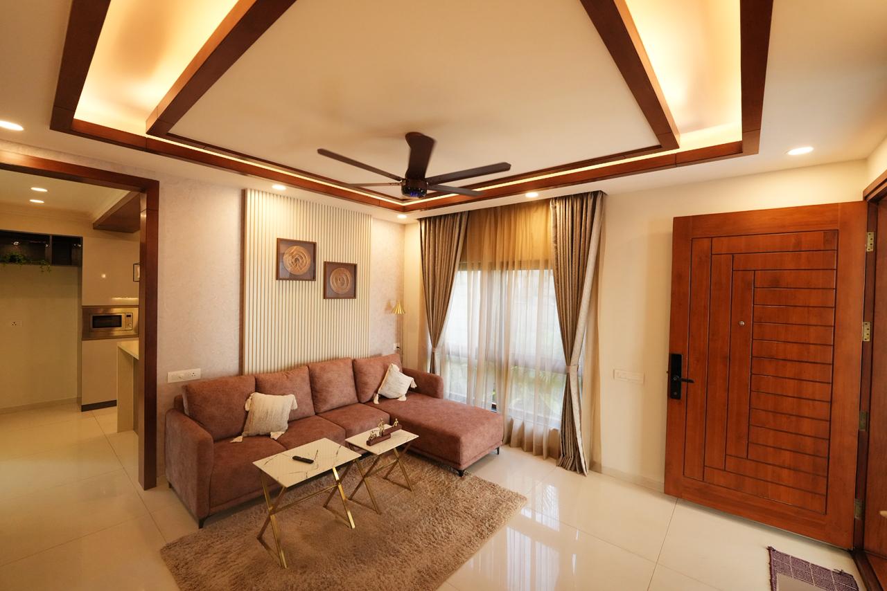 Spacious living room with wood-panelled false ceiling